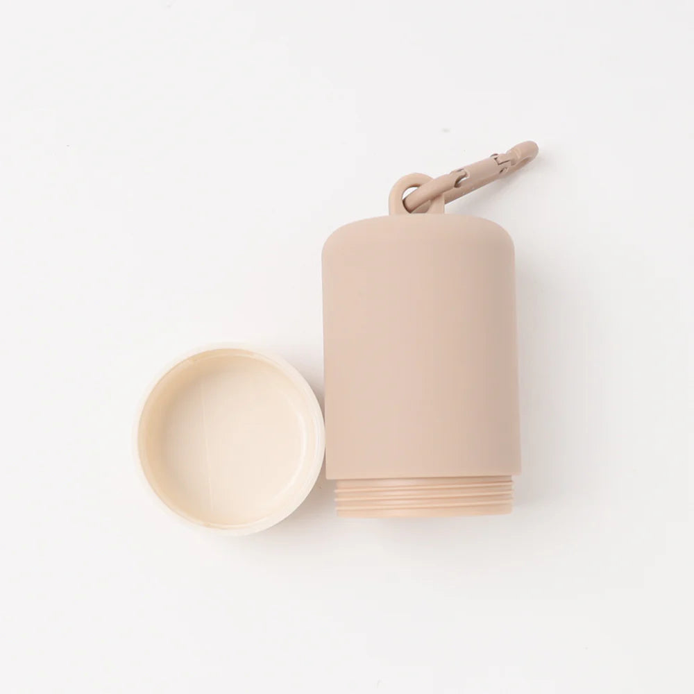 Beige plastic dog poop bag holder on a white background