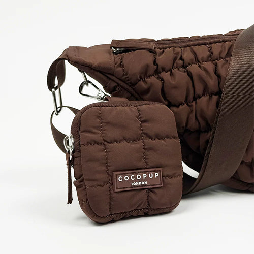 Brown quilted pet carrier with COCOPUP LONDON label on a white background