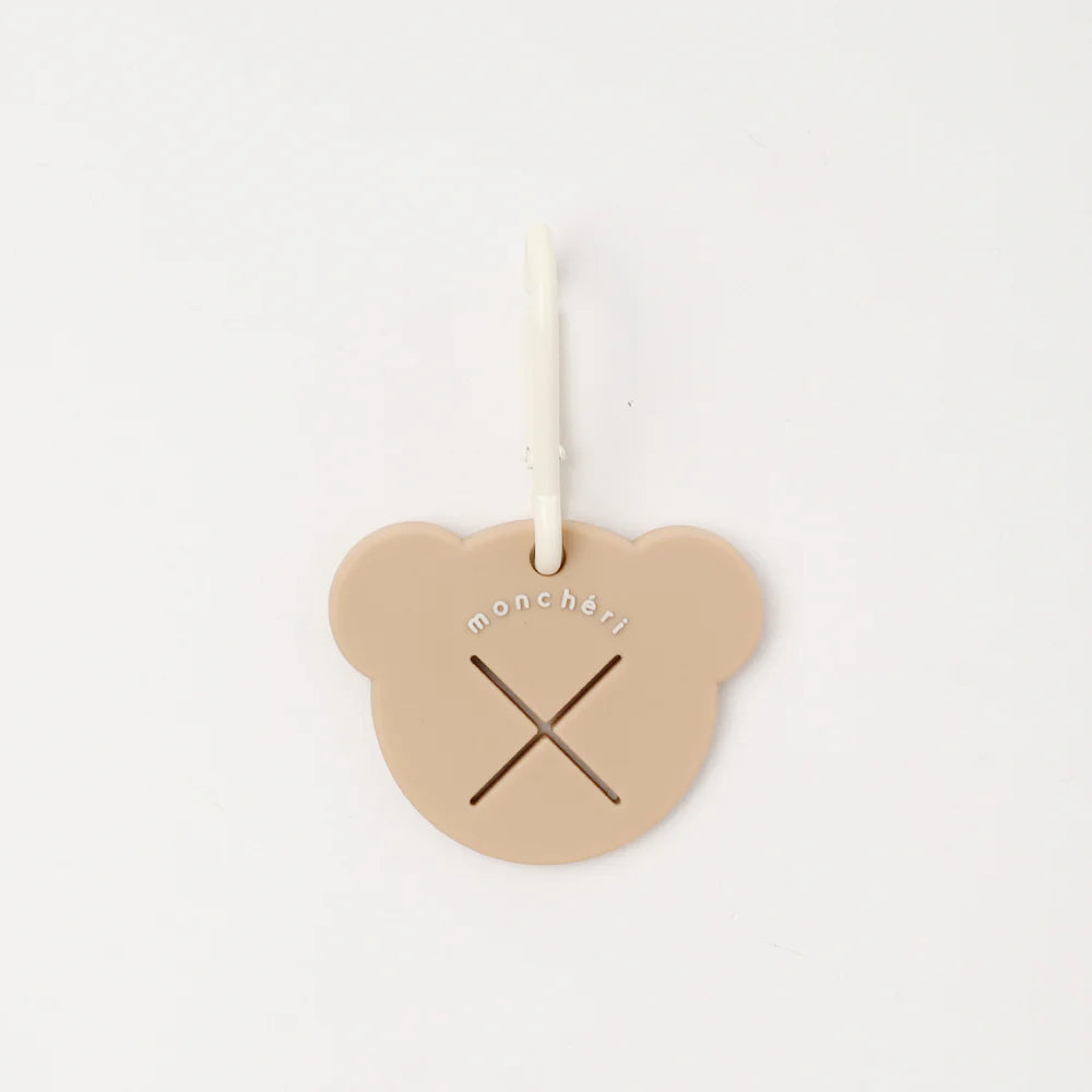 Heart-shaped beige tag with 'monchéri' branding on a white background