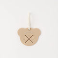 Heart-shaped beige tag with 'monchéri' branding on a white background