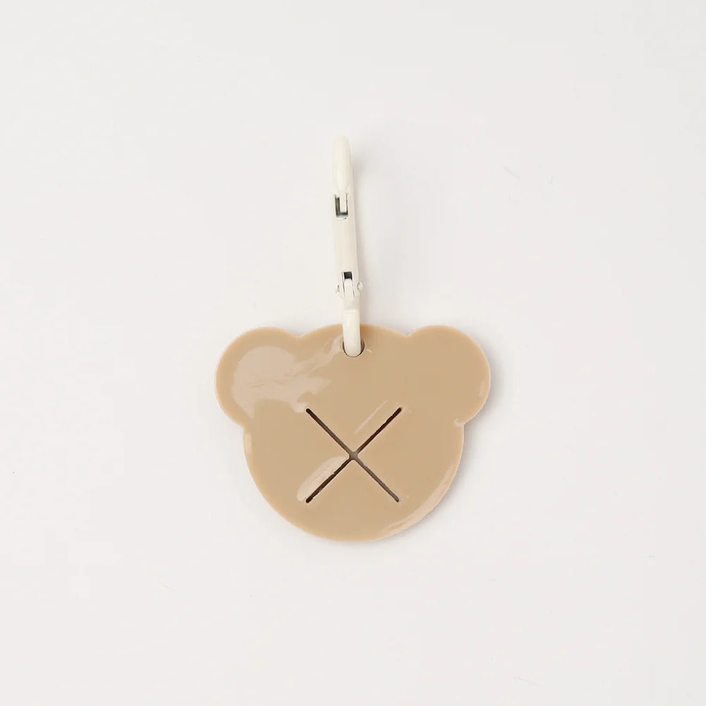 Beige bear-shaped dog poop bag holder on a white background